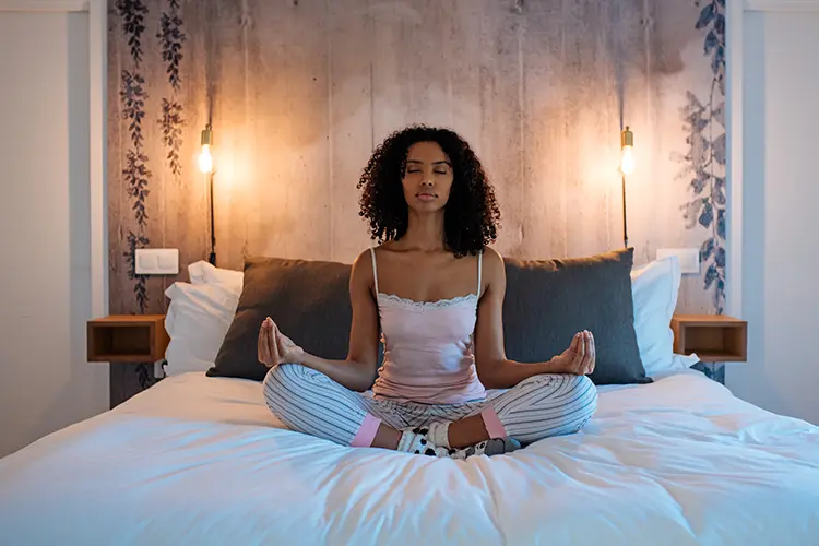 A person resting in a relaxed pose during a guided yoga nidra session