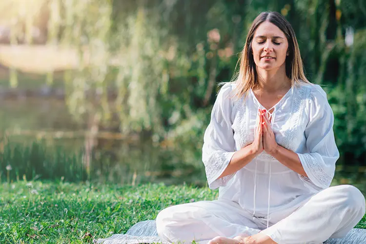 A yoga instructor demonstrating a pose to a small class